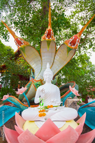 Buddha statue in a Thai temple, the name of the place is Wat Khunaram, Gautama is decorated with flowers of marigolds during a religious festival photo