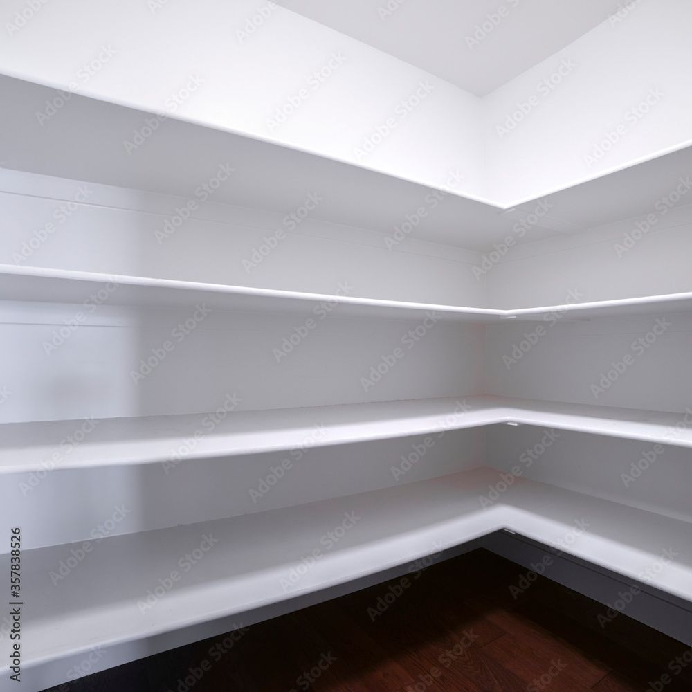 Square Empty white fitted shelves in an interior room Square Empty white fitted shelves in an interior room