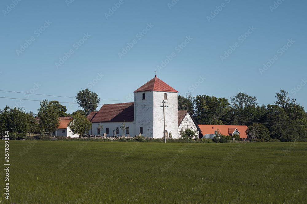 The medieval Fulltofta church stand close to the agricultural fields in the flat farmlands of Skåne (Scania) in southern Sweden