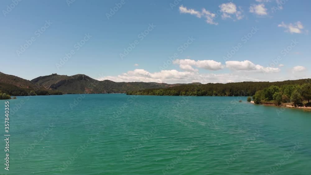 Ascending Aerial View of a Lake with Mountains in the Background Ascending Aerial View of a Lake with Mountains in the Background