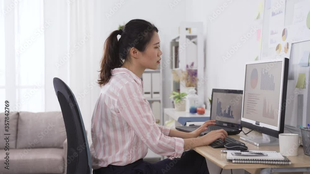 japanese female employee happy about completing a complex analytical task. asian office lady dealing with project with caution and finally having the work done.