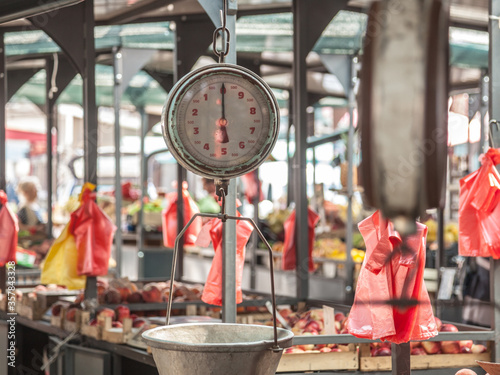 Old vintage retro Mechanical scale in front of a fruits and vegetables stand on the Zeleni Venac Pijaca market, one of the most iconic farmers green market of Balkans photo