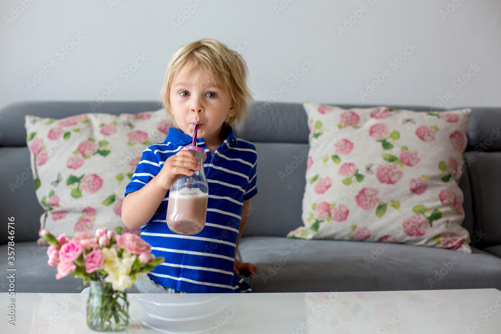 Happy school boy drinking a healthy smoothie Happy school boy drinking a healthy smoothie