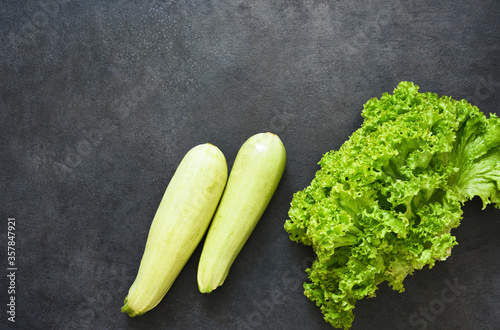 Fresh, organic vegetables on a black stone background. View from above. Bio vegetables.