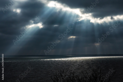 Rays of light shining through storm clouds.