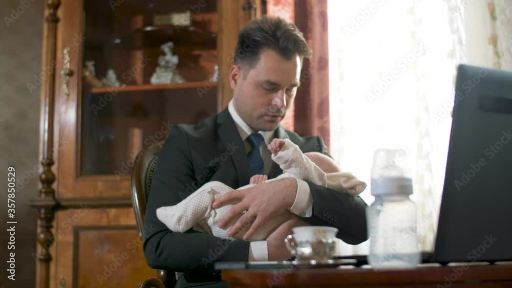 a male businessman in a suit at home, holds a child in his arms, and the transition focuses on a baby bunny notbook phone and a little cup of coffee