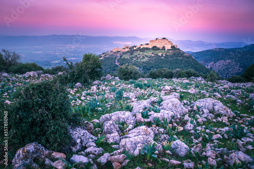 Beautiful pink sunrise sky over the Nimrod Fortress - ruins of a medieval Ayyubid castle located on the southern slopes of Mount Hermon, overlooking the Golan Heights, Northern Israel photo