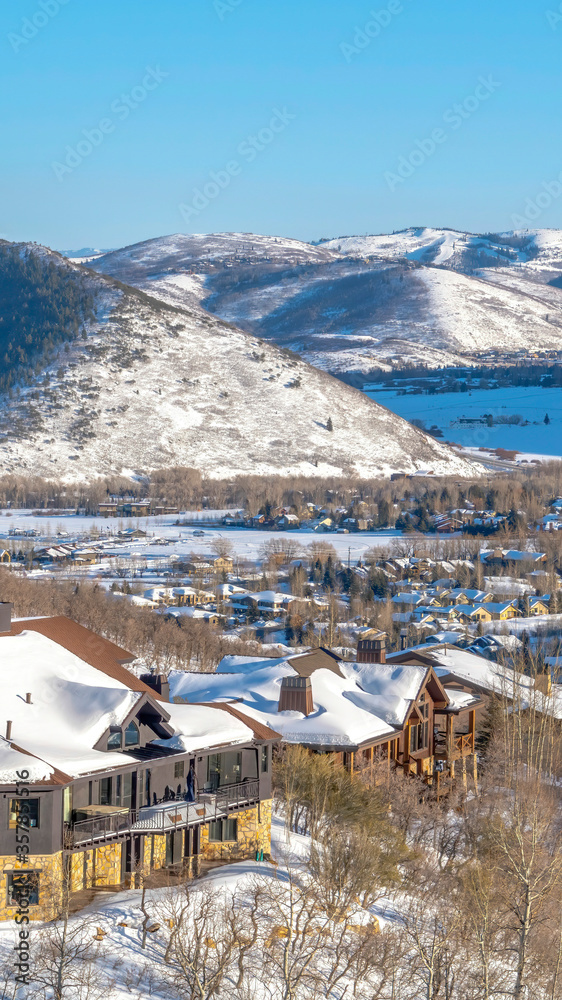 Vertical crop Picturesque Park City Utah winter landscape with snowy homes and frosted hills