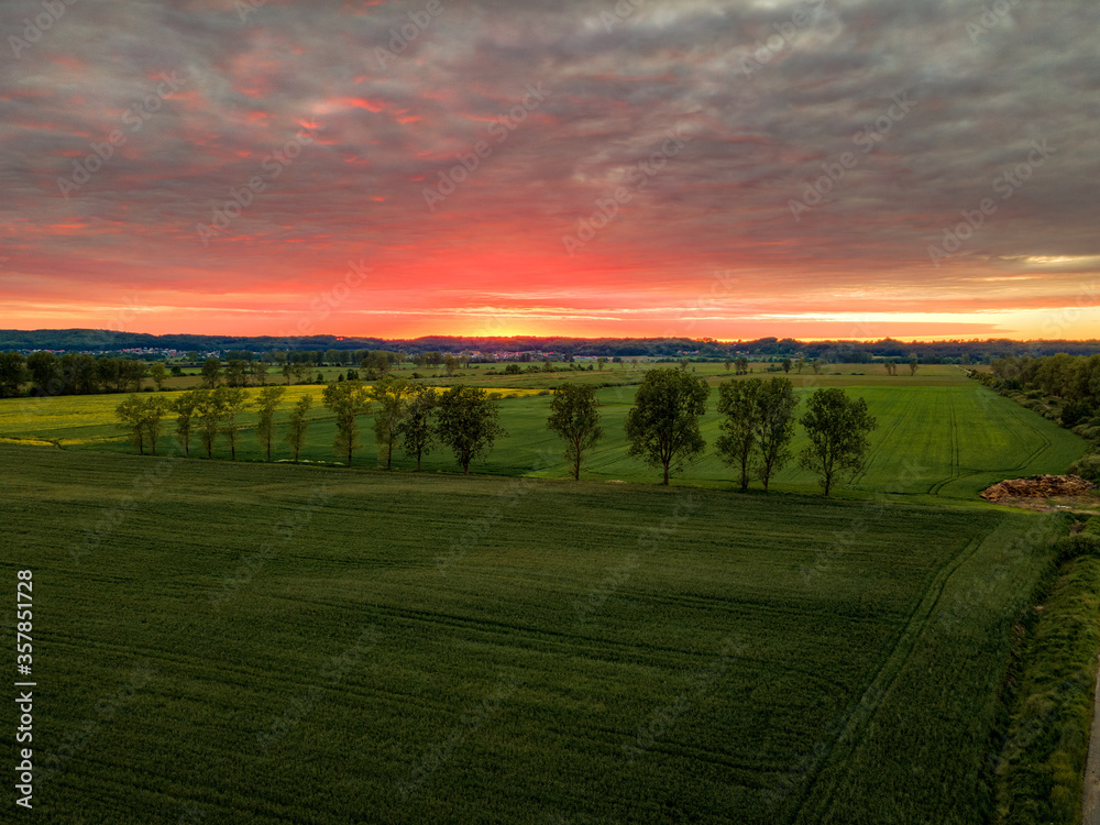 Naklejka premium Aerial view of arable fields during sunset