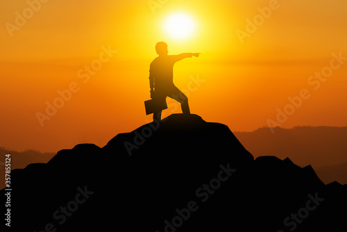 silhouette of a man on a mountain who achieve their goals