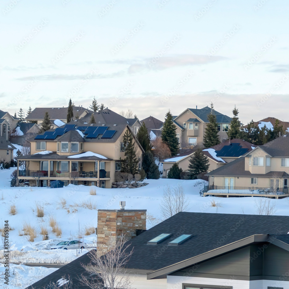 Square frame Homes of snowed in town situated amid scenic terrain of Wasatch Mountains