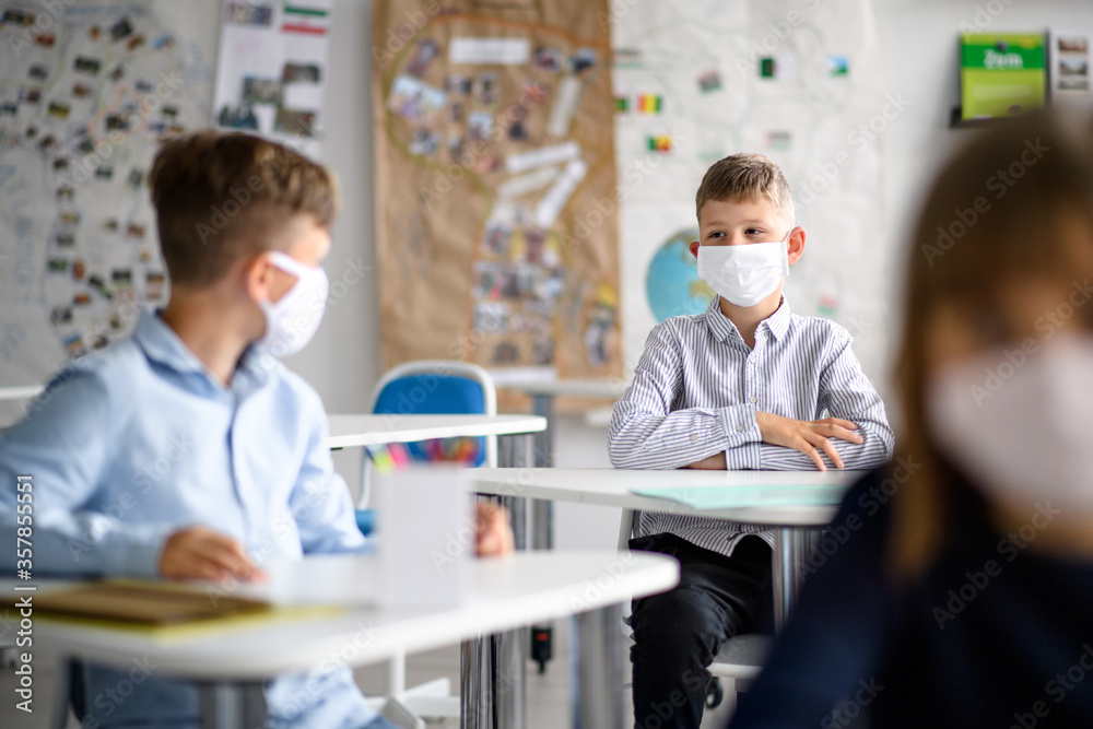 Obraz premium Group of children with face mask back at school after covid-19 quarantine and lockdown.
