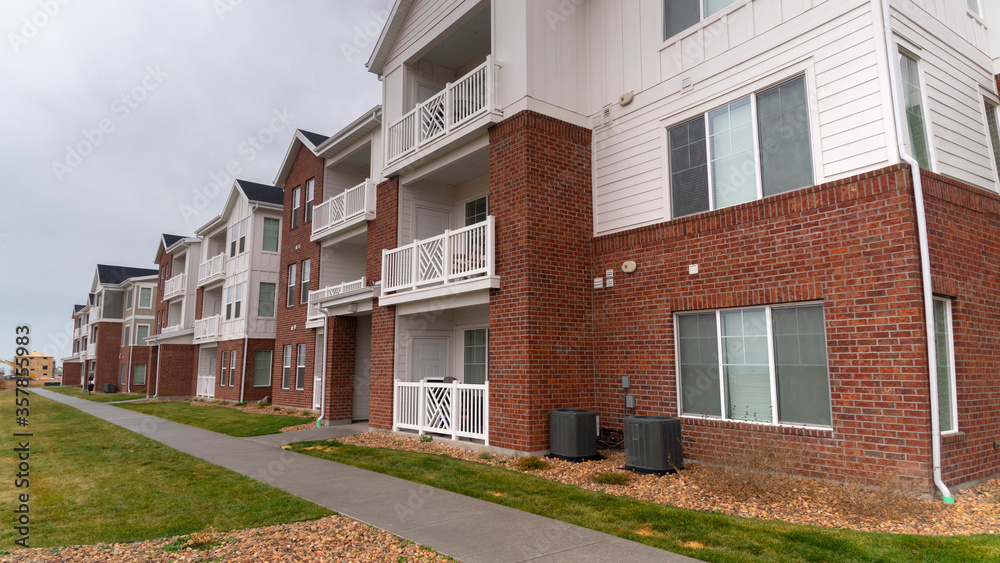 Panorama crop Receding view of a modern apartment complex Panorama crop Receding view of a modern apartment complex