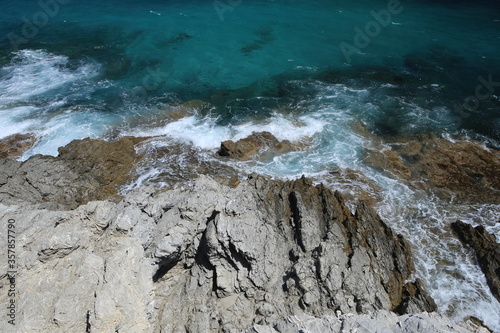 panorama landscape scenic view of isolated deserted rocky beach with blue turquoise sea water with white waves background on beautiful and colorful Mallorca island in Spain