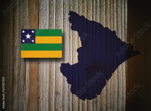 Map and flag of the province of Sergipe, Brazil, on a wooden background, 3D illustration