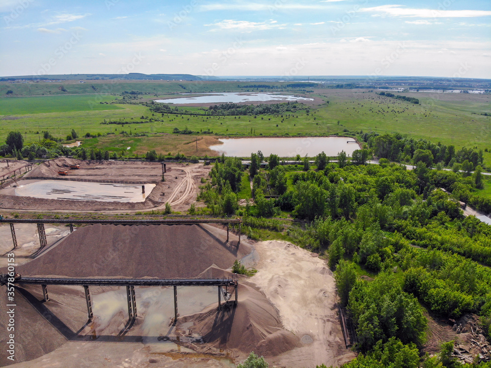 Aerial view of a sand and gravel processing plant near a river. Extraction, treatment and sale of all types of natural and artificial sand.