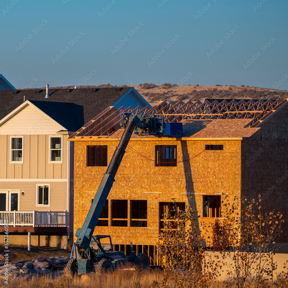 Square frame Constructing big frame house day light near sunset Square frame Constructing big frame house day light near sunset