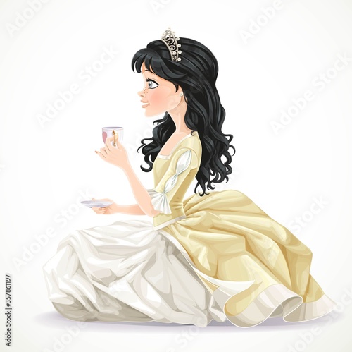 Beautiful brunette princess in yellow dress sitting on the floor with a cup of tea and saucer isolated on a white background