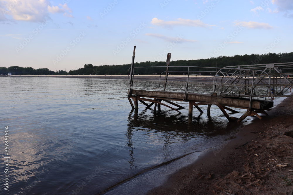 lake pier with metal railing in the morning