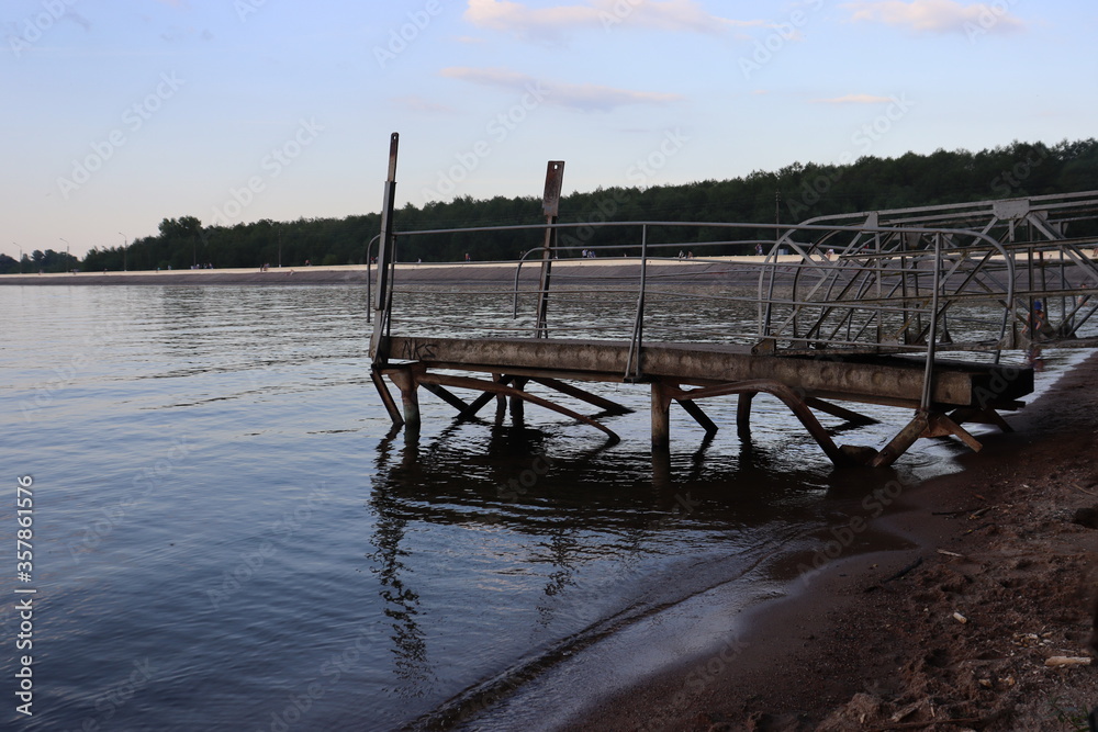 Obraz premium lake pier with metal railing in the morning