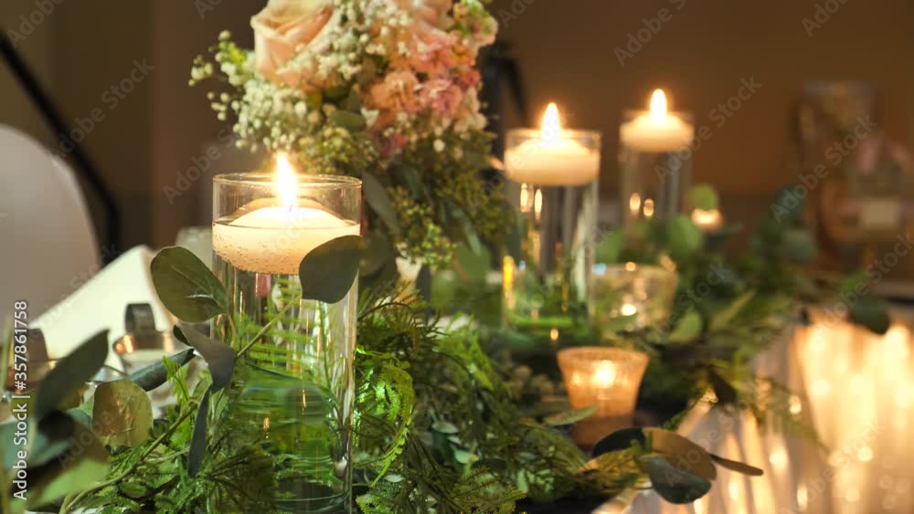 Floating Candles in Glasses on Head Table. Romantic Luxury Wedding Celebration Settings, Close Up Floating Candles in Glasses on Head Table. Romantic Luxury Wedding Celebration Settings, Close Up