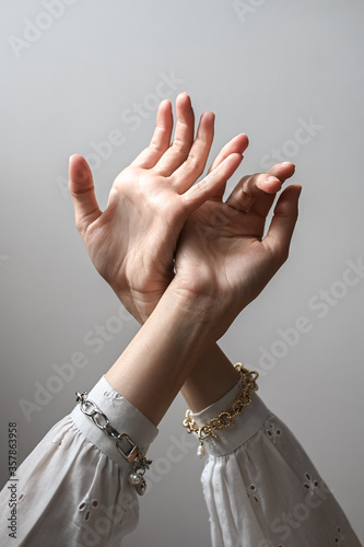 Female hands with bracelets. Tightened female hands with precious bracelets photo