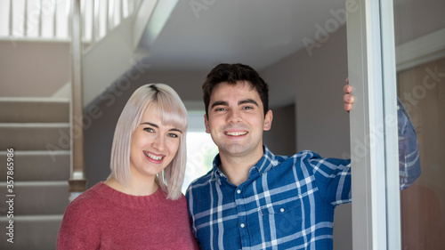 Portrait Of Smiling Young Couple Opening Front Door Of New Home © Daisy Daisy