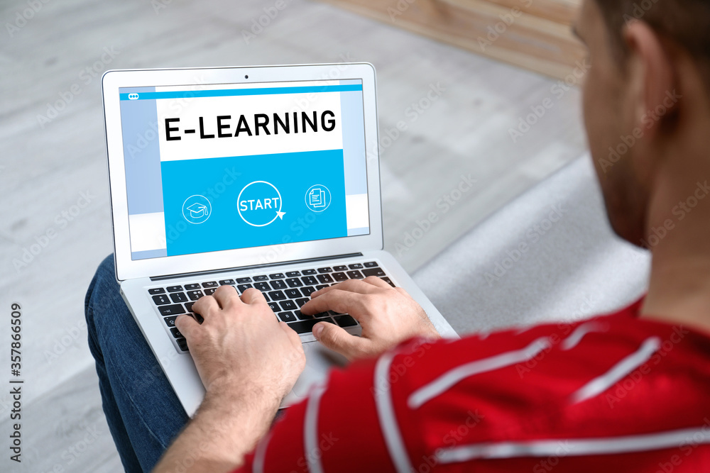 Man using laptop for online studying indoors, closeup. Adult education Man using laptop for online studying indoors, closeup. Adult education