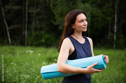 Girl does yoga outdoors in summer