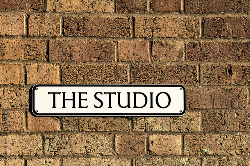 THE STUDIO SIGN ON BRICK UK IN ENGLISH