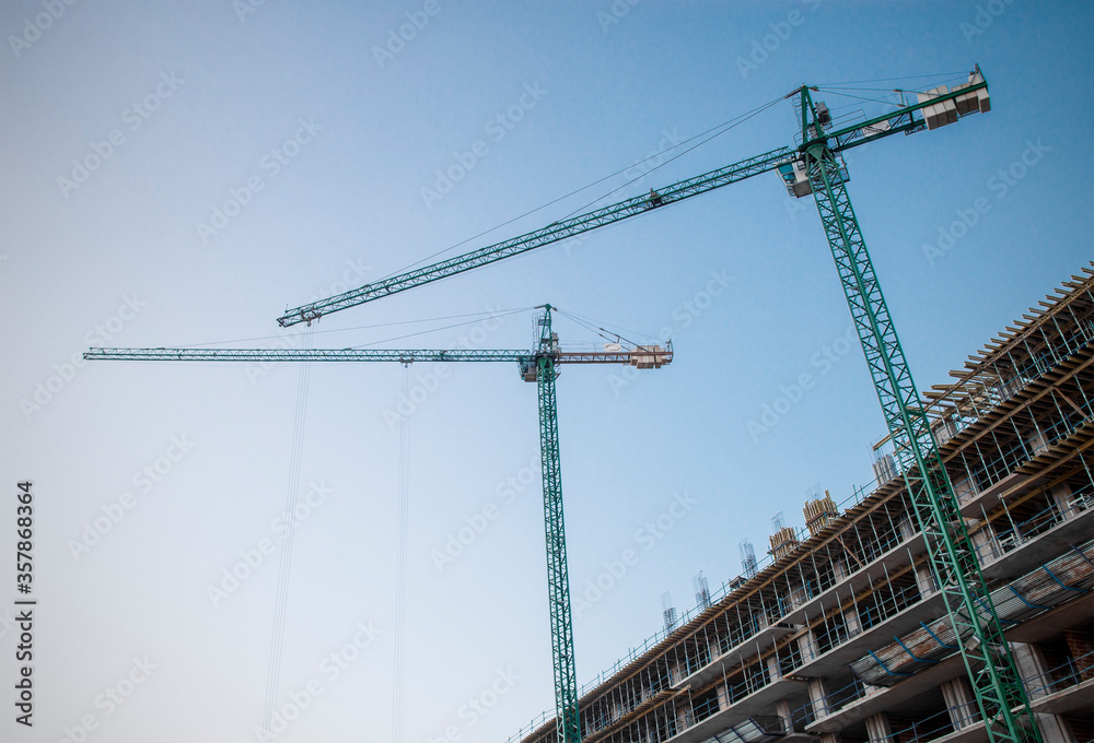 
Construction of building with cranes