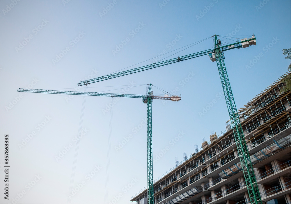 
Construction of building with cranes