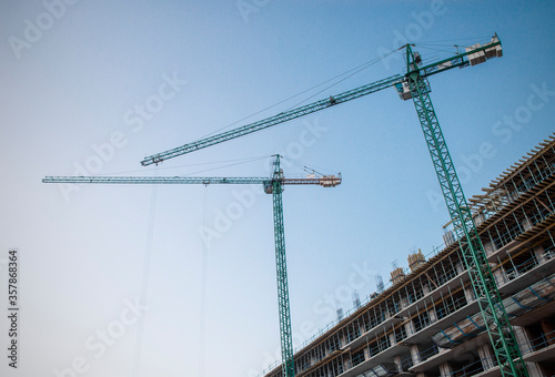 Construction of building with cranes