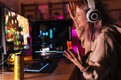 Image of displeased girl expressing irritation while playing video game