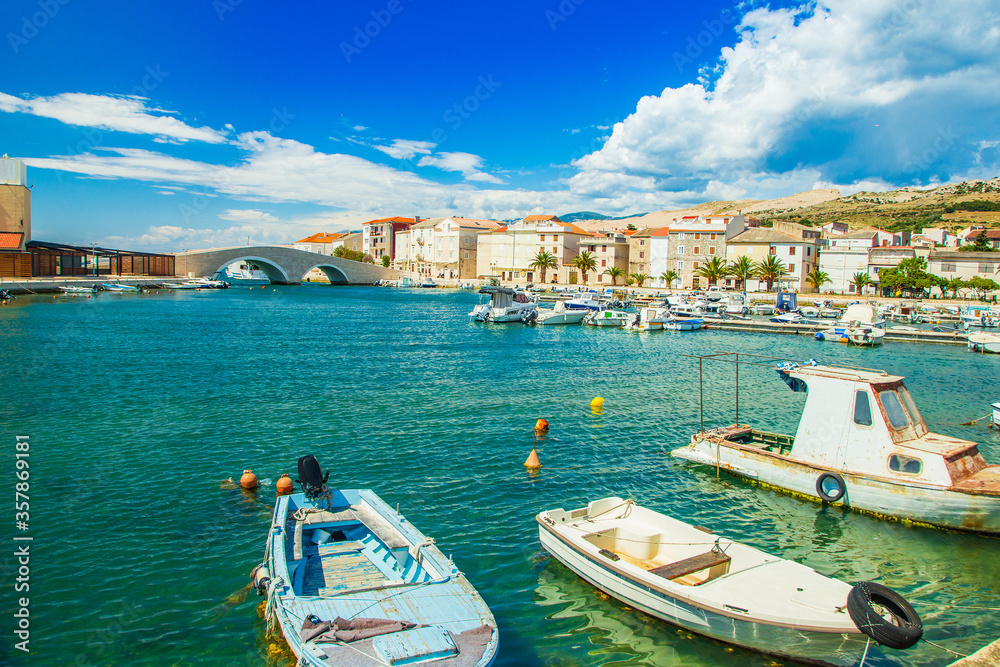 Adriatic sea in Croatia, beautiful old town of Pag, old stone bridge and marina with boats