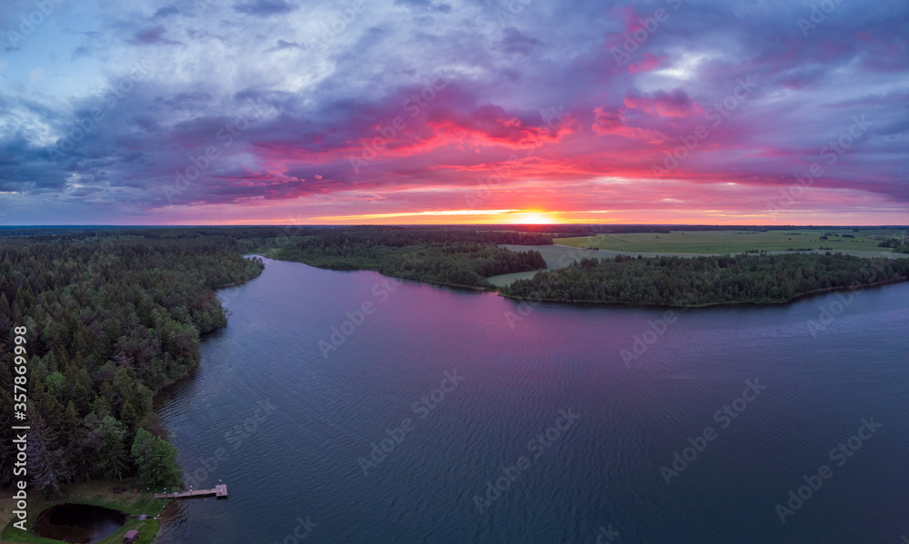 Fototapeta premium Magical purple sunset over lake in Belarus. Drone aerial photo