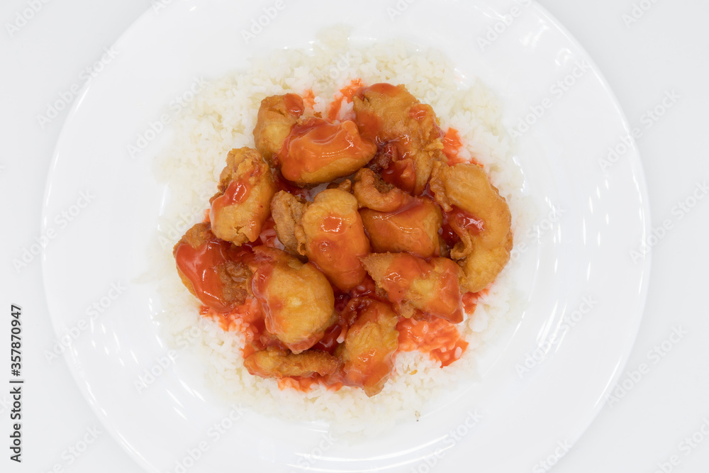 Sweet and Sour Chicken on White Rice on top of a White Plate Sweet and Sour Chicken on White Rice on top of a White Plate