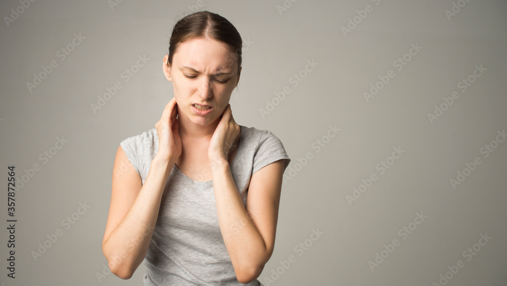 Obraz premium Tired woman feeling pain, massaging tense muscles
