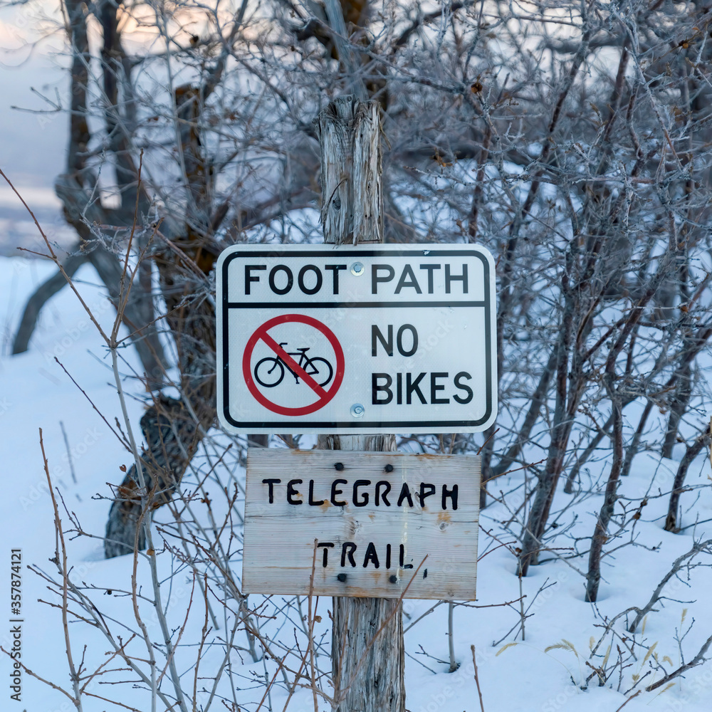 Square crop Signages by a foot path trail at Wasatch Mountains blanketed with snow in winter
