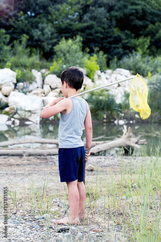 village boy with a net near the river photo