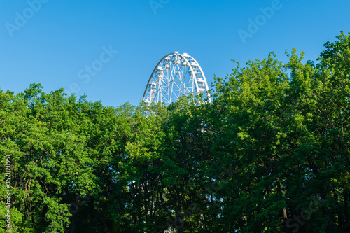 White Ferris wheel in the city Park against the blue sky