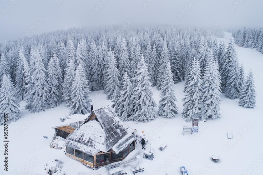 Drone view of a mountain villa covered in snow after blizzard