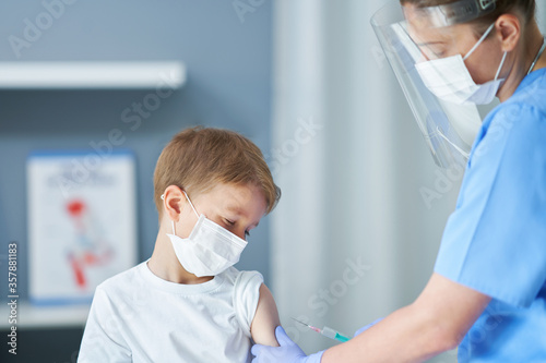 Portrait of adorable little boy being vaccinate at doctor s office
