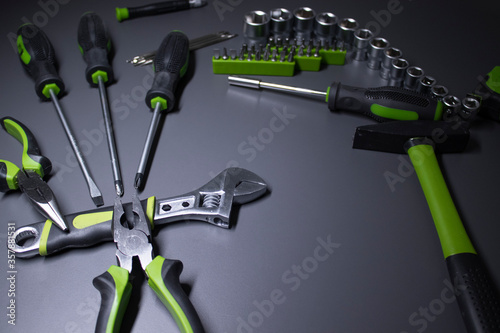 A set of building tools and instruments for repair in black and green colour. Must-have for men. Equipment for building. Repair tool kit. construction concept. gray background . High quality photo photo