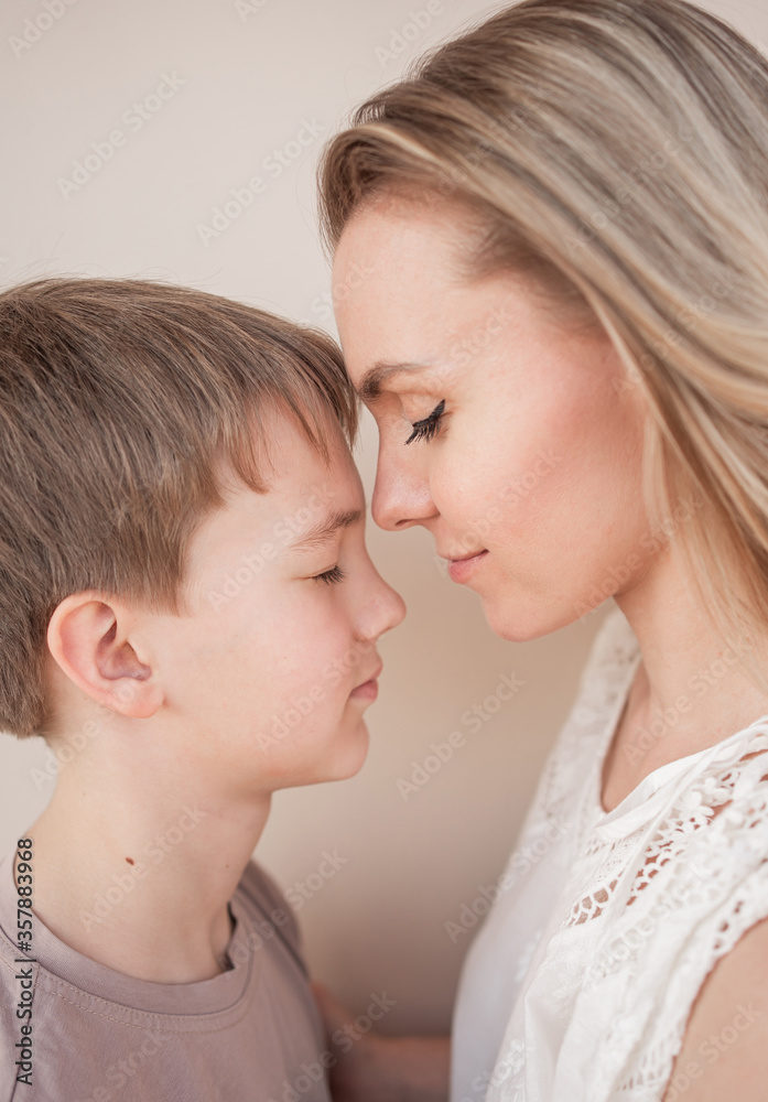 Mom teenager. Mother and son standing in front of each other. Family love. Mom teenager. Mother and son standing in front of each other. Family love.
