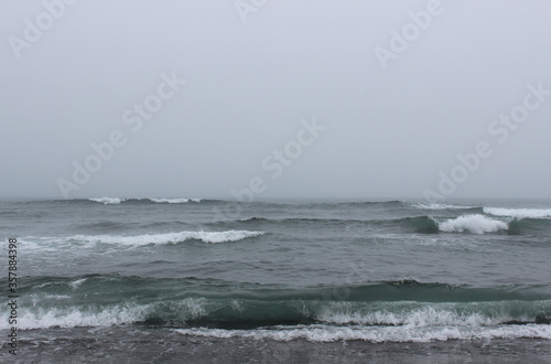 A gloomy landscape - Khalaktyrsky beach in a stormy weather at early august morning, Pacific ocean, Kamchatka Peninsula, Far East Russia