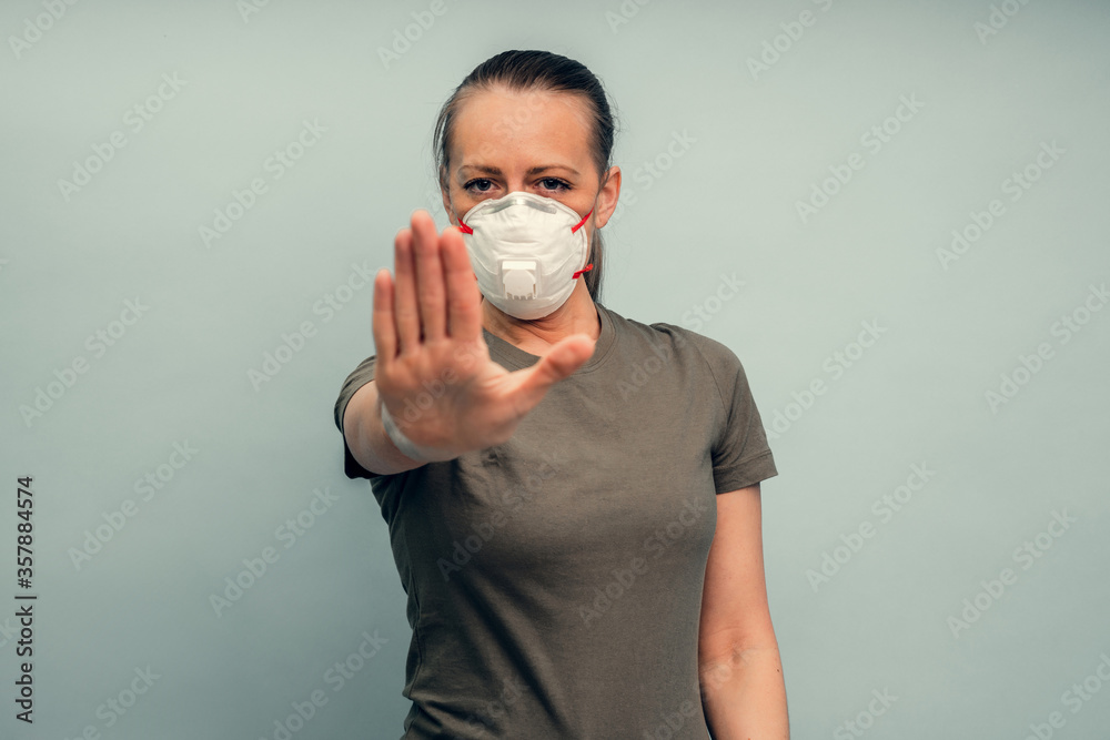 A girl is putting on a protective mask. Respiratory protection from coronavirus. Keep the distance. Personal protective equipment for a pandemic of a viral infection. Covid-19. A girl is putting on a protective mask. Respiratory protection from coronavirus. Keep the distance. Personal protective equipment for a pandemic of a viral infection. Covid-19.
