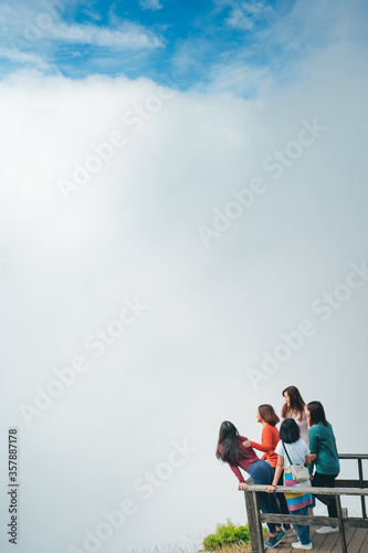 group asian woman traveler embracing nature from top of mountain in spring season