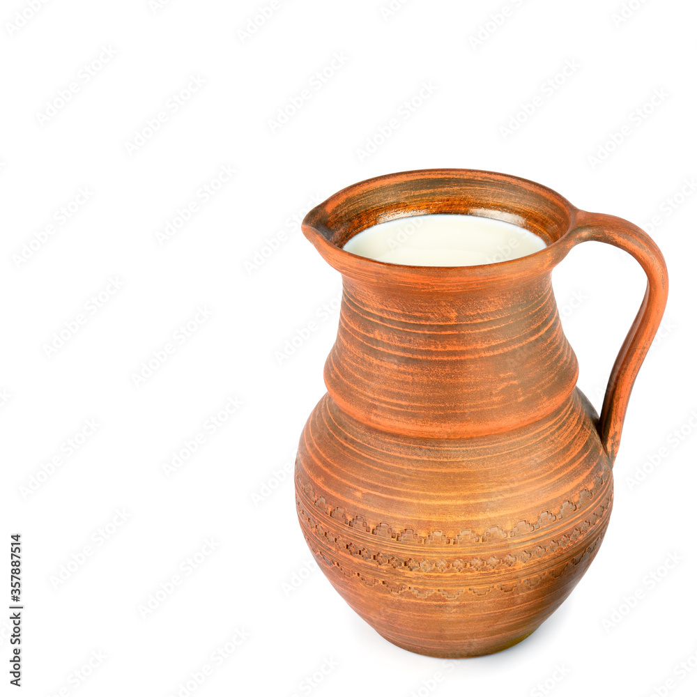 Clay jug with fresh milk isolated on white background. Free space for text.