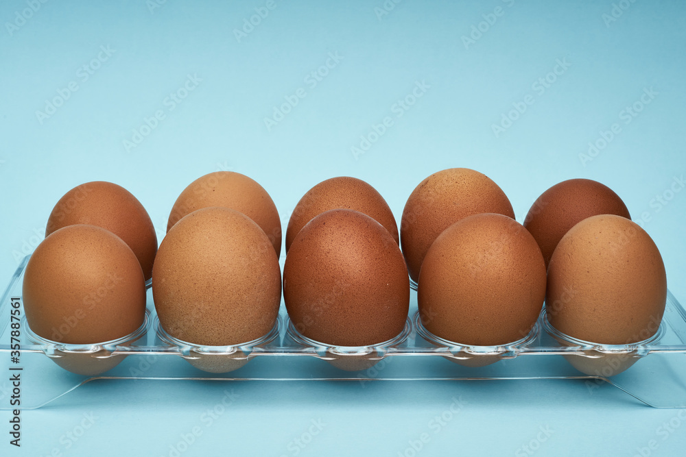 Chicken eggs in an egg holder. Full tray of eggs. Half an egg, egg yolk, shell. Food, protein in foods. Chicken eggs in an egg holder. Full tray of eggs. Half an egg, egg yolk, shell. Food, protein in foods.